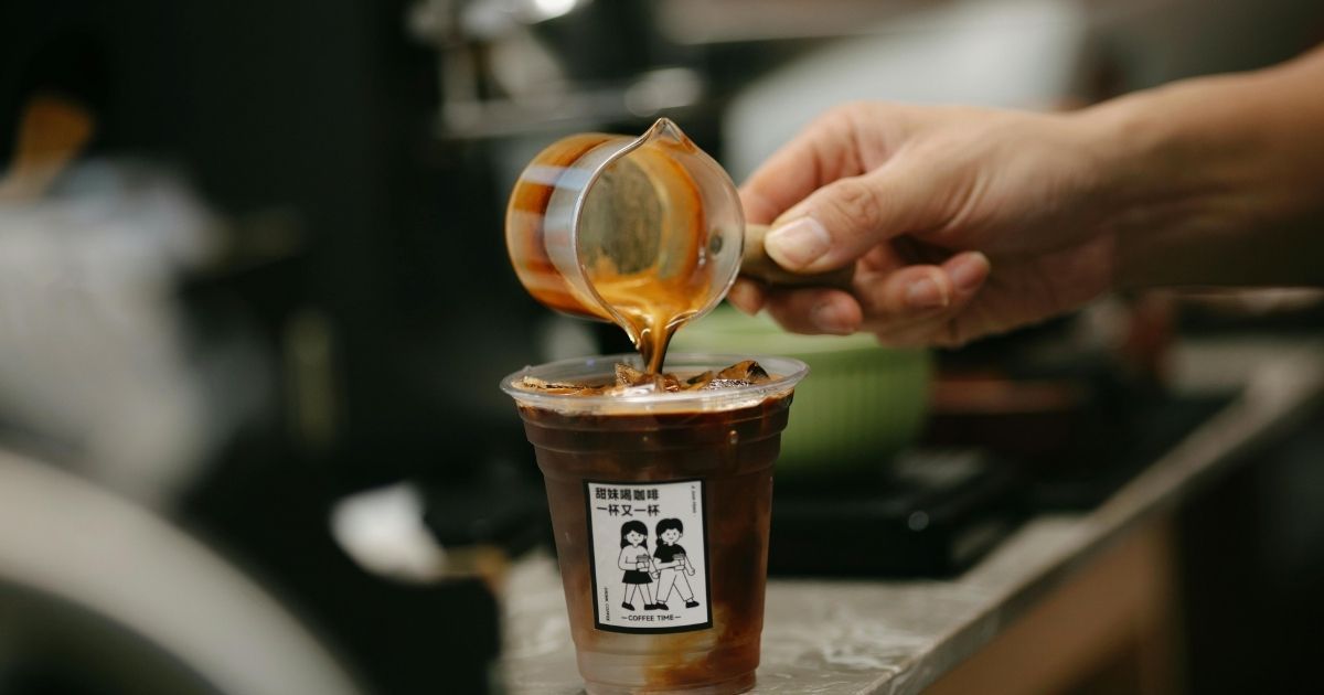 Dunkin iced coffees side by side showing the visual difference between a Flavor Shot and a Flavor Swirl